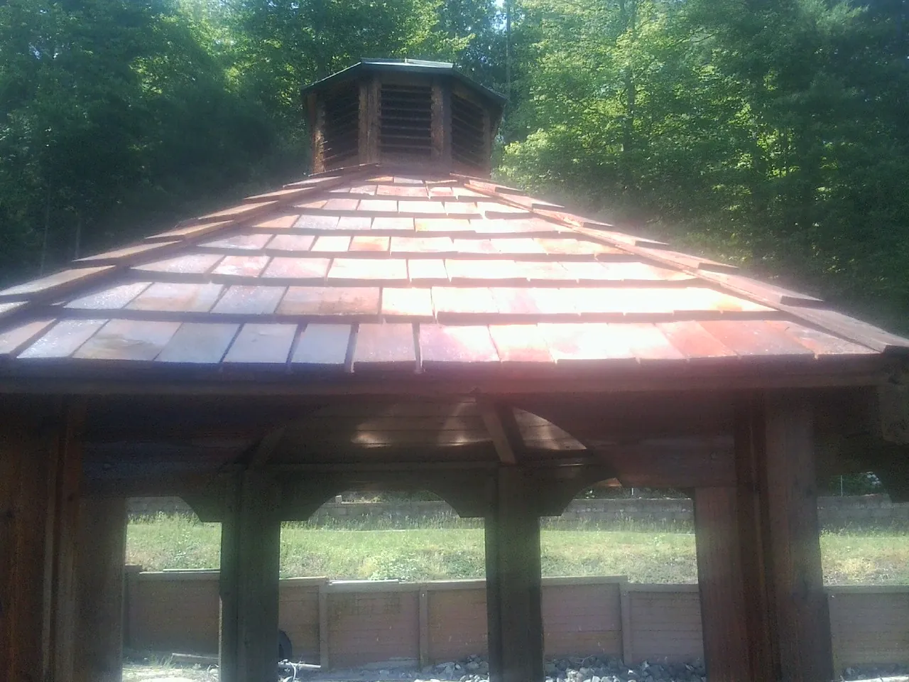 New cedar shake roof and cupola on a lakeside gazebo in Newport